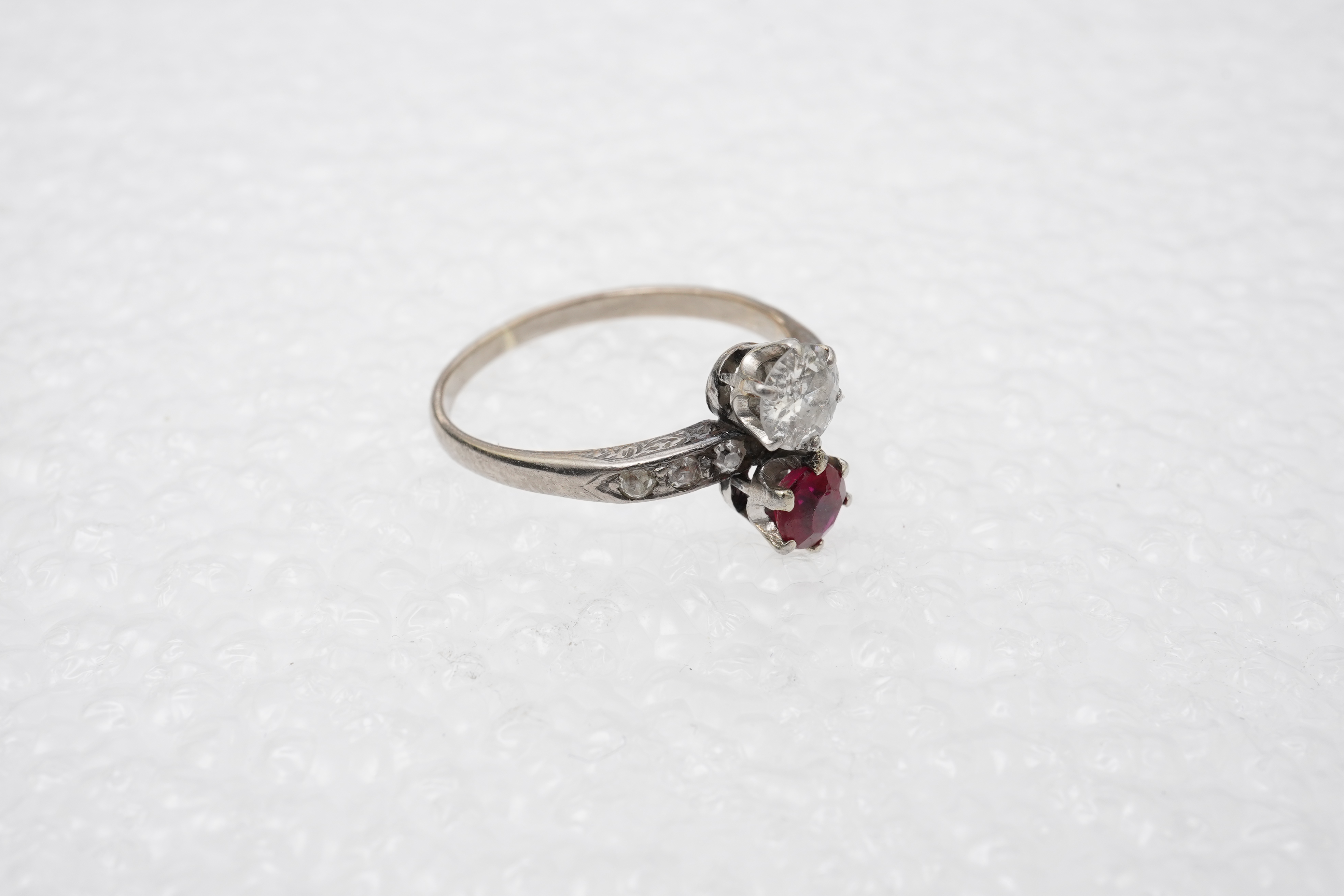 A synthetic ruby and diamond 'toi-et-moi' ring, early 20th century